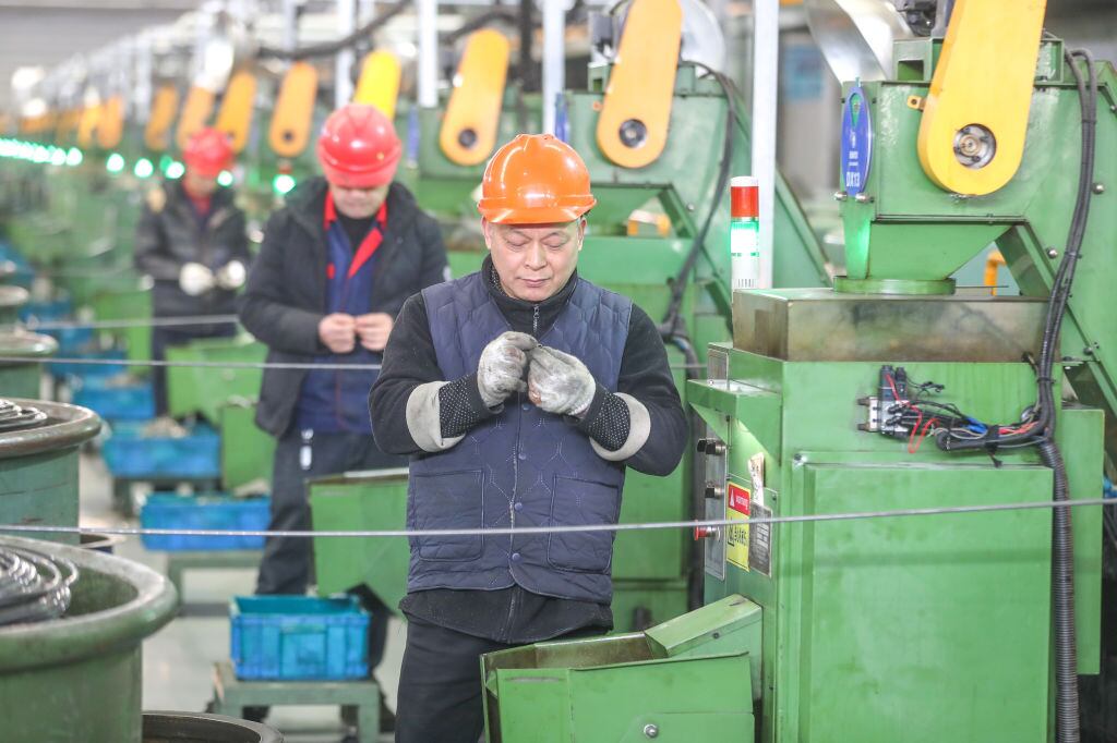 Trabajadores se desempeñan al interior de una fábrica que exporta materiales de transmisión desde Huzhou en China.