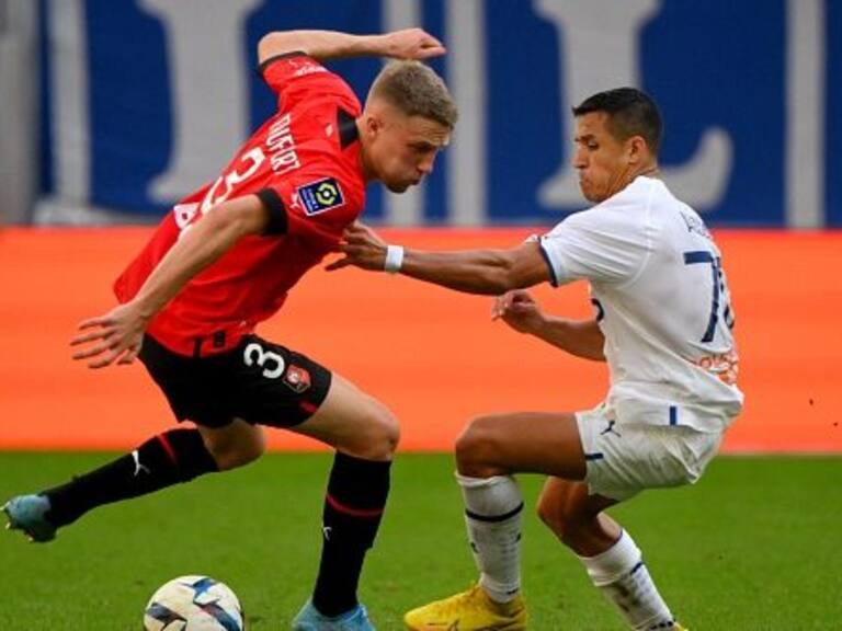 Rennes' French defender Adrien Truffert (L) fights for the ball with Marseille's Chilean forward Alexis Sanchez (R) during the French L1 football match between Olympique Marseille (OM) and Stade Rennais FC (Rennes) at Stade Velodrome in Marseille, southern France on September 18, 2022. (Photo by Nicolas TUCAT / AFP) (Photo by NICOLAS TUCAT/AFP via Getty Images)