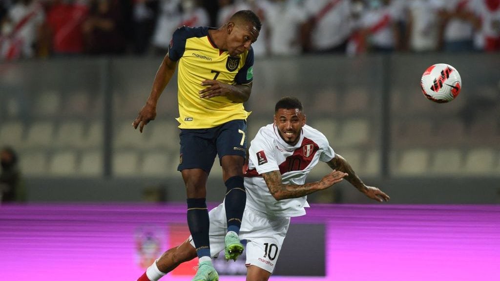 Ecuador's Pervis Estupinan (L) and Peru's Sergio Pena (R) vie for the ball during their South American qualification football match for the FIFA World Cup Qatar 2022, at the National Stadium in Lima on February 1, 2022. (Photo by ERNESTO BENAVIDES / AFP) (Photo by ERNESTO BENAVIDES/AFP via Getty Images)