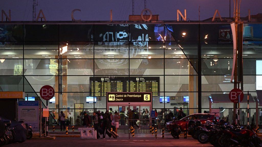 People wait outside the closed Jorge Chavez International Airport after the accident of the LA2213 flight in Lima, on November 18, 2022. - Two firefighters died this Friday after their vehicle collided with a Latam airline plane that was taking off from the Lima airport for a domestic flight, an incident that the Peruvian prosecutor's office will investigate "for possible crimes of homicide and injuries." (Photo by ERNESTO BENAVIDES / AFP) (Photo by ERNESTO BENAVIDES/AFP via Getty Images)