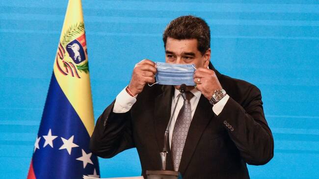 CARACAS, VENEZUELA - FEBRUARY 17: Nicolas Maduro President of Venezuela puts on his protective facemask after he gave a press conference in Miraflores Palace on February 17, 2021 in Caracas, Venezuela. Nicolas Maduro President of Venezuela announced the country will start vaccinating health workers from Thursday with the Covid-19 Vaccine Sputnik V. (Photo by Carolina Cabral/Getty Images)