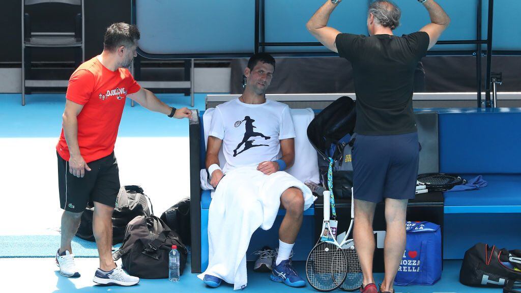 MELBOURNE, AUSTRALIA - JANUARY 11: Novak Djokovic of Serbia practices on Rod Laver Arena ahead of the 2022 Australian Open at Melbourne Park on January 11, 2022 in Melbourne, Australia. Djokovic arrived in Melbourne on Thursday night to play in the upcoming Australian Open and was denied entry to Australia due to his inability to meet Australian entry requirements. He was sent to an immigration detention hotel while the decision to cancel his visa was reviewed in the Australian Federal Circuit Court. Djokovic was granted permission to enter Australia on Monday night and resumed practising soon after with another session this afternoon, while the Federal Government decides if they should still cancel his visa. (Photo by Kelly Defina/Getty Images)
