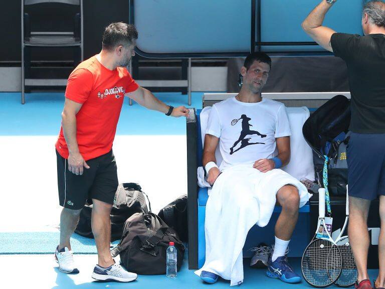 MELBOURNE, AUSTRALIA - JANUARY 11: Novak Djokovic of Serbia practices on Rod Laver Arena ahead of the 2022 Australian Open at Melbourne Park on January 11, 2022 in Melbourne, Australia. Djokovic arrived in Melbourne on Thursday night to play in the upcoming Australian Open and was denied entry to Australia due to his inability to meet Australian entry requirements. He was sent to an immigration detention hotel while the decision to cancel his visa was reviewed in the Australian Federal Circuit Court. Djokovic was granted permission to enter Australia on Monday night and resumed practising soon after with another session this afternoon, while the Federal Government decides if they should still cancel his visa. (Photo by Kelly Defina/Getty Images)