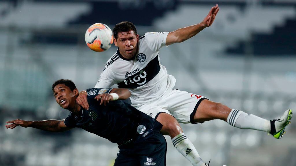 Brazil's Santos player Raniel (L) and Paraguay's Olimpia defender Jose Leguizamon vie for the ball during their closed-door Copa Libertadores group phase football match at the Manuel Ferreira Stadium in Asuncion, on October 1, 2020, amid the COVID-19 novel coronavirus pandemic. (Photo by Jorge SAENZ / POOL / AFP) (Photo by JORGE SAENZ/POOL/AFP via Getty Images)