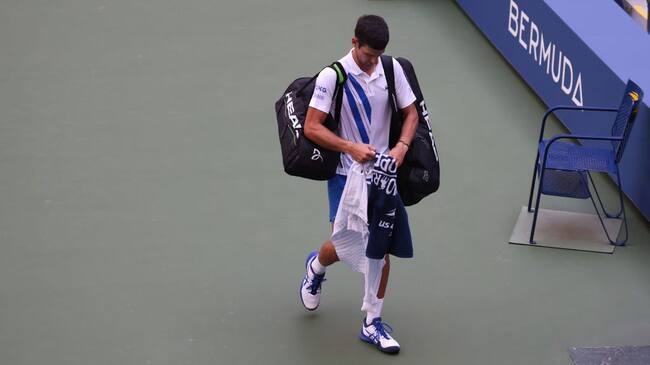 NEW YORK, NEW YORK - SEPTEMBER 06: Novak Djokovic of Serbia walks off the court after being defaulted due to inadvertently striking a lineswoman with a ball hit in frustration during his Men's Singles fourth round match against Pablo Carreno Busta of Spain on Day Seven of the 2020 US Open at the USTA Billie Jean King National Tennis Center on September 6, 2020 in the Queens borough of New York City. (Photo by Al Bello/Getty Images)
