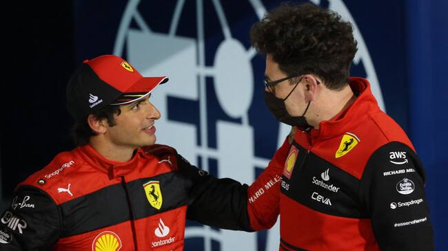 Second placed Ferrari's Spanish driver Carlos Sainz Jr (L) talks with Ferrari team principal Mattia Binotto after the Bahrain Formula One Grand Prix at the Bahrain International Circuit in the city of Sakhir on March 20, 2022. (Photo by Giuseppe CACACE / AFP) (Photo by GIUSEPPE CACACE/AFP via Getty Images)