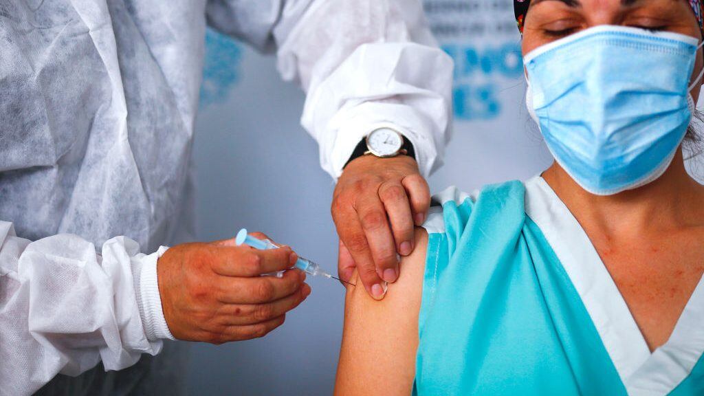 QUILMES, ARGENTINA - DECEMBER 29: Maria Arreola, a nurse at Isidoro Iriarte Hospital, receives the first dose of 'Gam-COVID-Vac' also known as Sputnik V vaccine against coronavirus at Isidoro Iriarte Hospital on December 29, 2020 in Quilmes, Argentina. Argentine government begins today the campaign to apply the first 300,000 doses that arrived from Russia. (Photo by Marcos Brindicci/Getty Images)
