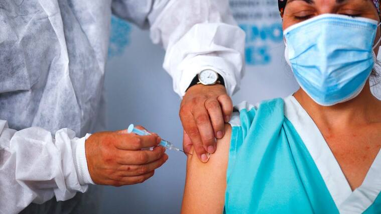 QUILMES, ARGENTINA - DECEMBER 29: Maria Arreola, a nurse at Isidoro Iriarte Hospital, receives the first dose of 'Gam-COVID-Vac' also known as Sputnik V vaccine against coronavirus at Isidoro Iriarte Hospital on December 29, 2020 in Quilmes, Argentina. Argentine government begins today the campaign to apply the first 300,000 doses that arrived from Russia. (Photo by Marcos Brindicci/Getty Images)
