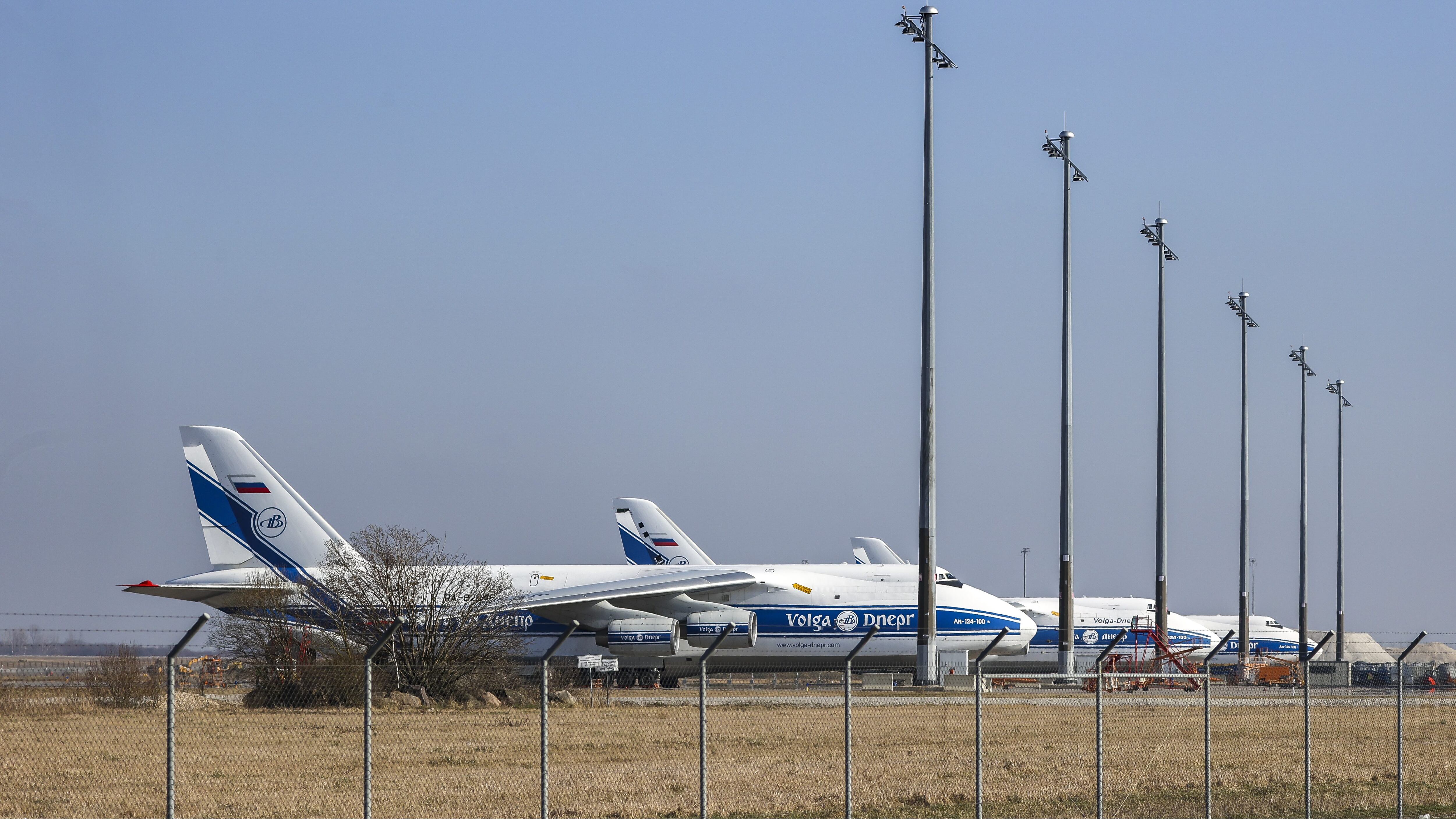 28 February 2022, Saxony, Schkeuditz: Three Antonov An-124 cargo aircraft of the Russian Volga-Dnepr Group are parked at Leipzig/Halle Airport. The aircraft are no longer allowed to take off because EU airspace is closed to Russian aircraft. Photo: Jan Woitas/dpa-Zentralbild/dpa (Photo by Jan Woitas/picture alliance via Getty Images)