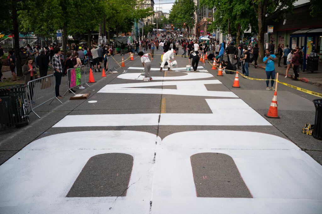 SEATTLE, WA - JUNE 10: People paint a Black Lives Matter mural on East Pine Street in the so-called "Capitol Hill Autonomous Zone" on June 10, 2020 in Seattle, Washington. The zone includes the blocks surrounding the Seattle Police Departments East Precinct, which was the site of violent clashes with Black Lives Matter protesters, who have continued to demonstrate in the wake of George Floyds death. (Photo by David Ryder/Getty Images)
