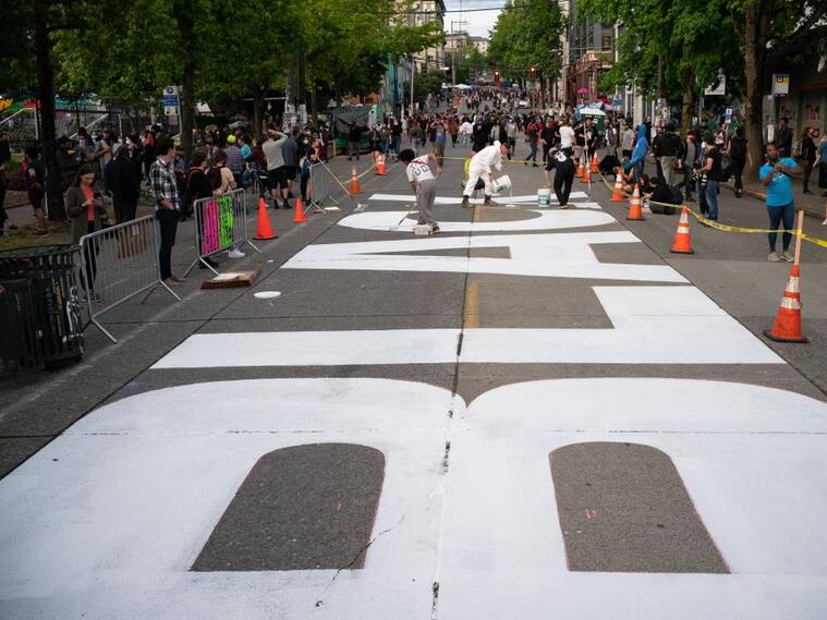 SEATTLE, WA - JUNE 10: People paint a Black Lives Matter mural on East Pine Street in the so-called "Capitol Hill Autonomous Zone" on June 10, 2020 in Seattle, Washington. The zone includes the blocks surrounding the Seattle Police Departments East Precinct, which was the site of violent clashes with Black Lives Matter protesters, who have continued to demonstrate in the wake of George Floyds death. (Photo by David Ryder/Getty Images)