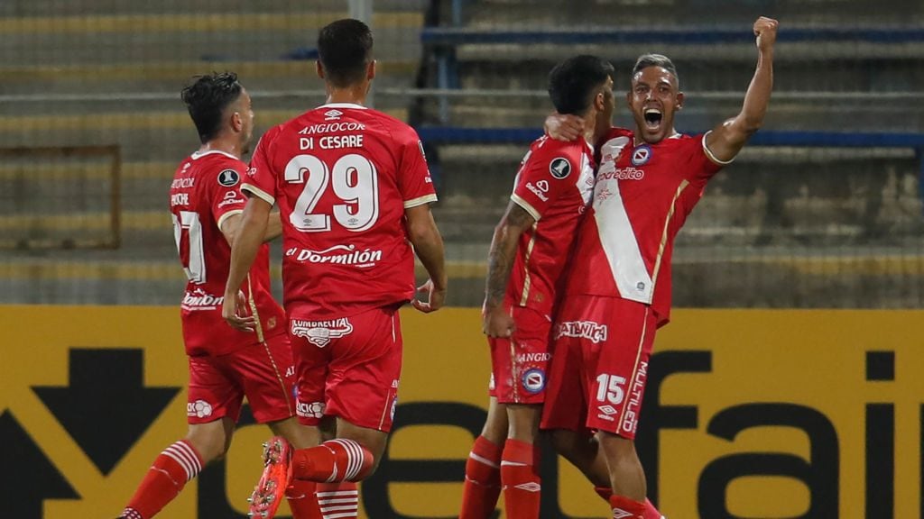 Argentina's Argentinos Juniors Cesar Florentin (2nd R) celebrates with teammate Uruguayan Jonathan Sandoval (R) after scoring against Chile's Universidad Catolica during the Copa Libertadores football tournament group stage match at the San Carlos de Apoquindo Stadium in Santiago, on April 29, 2021. (Photo by Alberto Valdes / POOL / AFP) (Photo by ALBERTO VALDES/POOL/AFP via Getty Images)