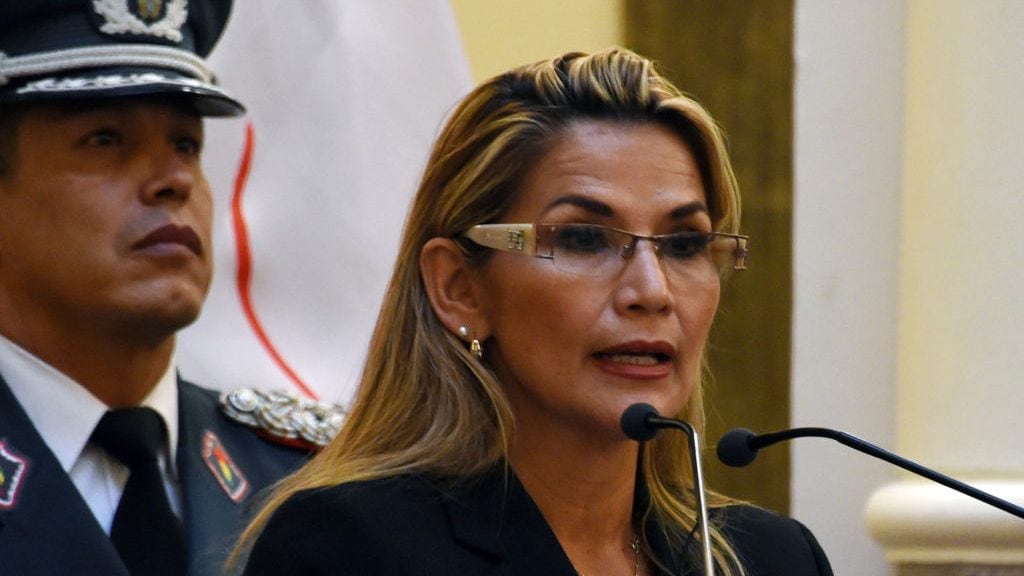 Bolivia's interim president, Jeanine Anez speaks while taking oath to the military command during her first day in power, at the Quemado presidential palace in La Paz, on November 13, 2019. - Anez, who declared herself interim president before her claim was endorsed by the constitutional court, arguing that her succession was necessitated by the resignations of those above her in the government hierarchy, will try to fill the power vacuum left by Evo Morales's abrupt resignation, as the former leader denounced what he described as a "sneaky coup." (Photo by AIZAR RALDES / AFP) (Photo by AIZAR RALDES/AFP via Getty Images)