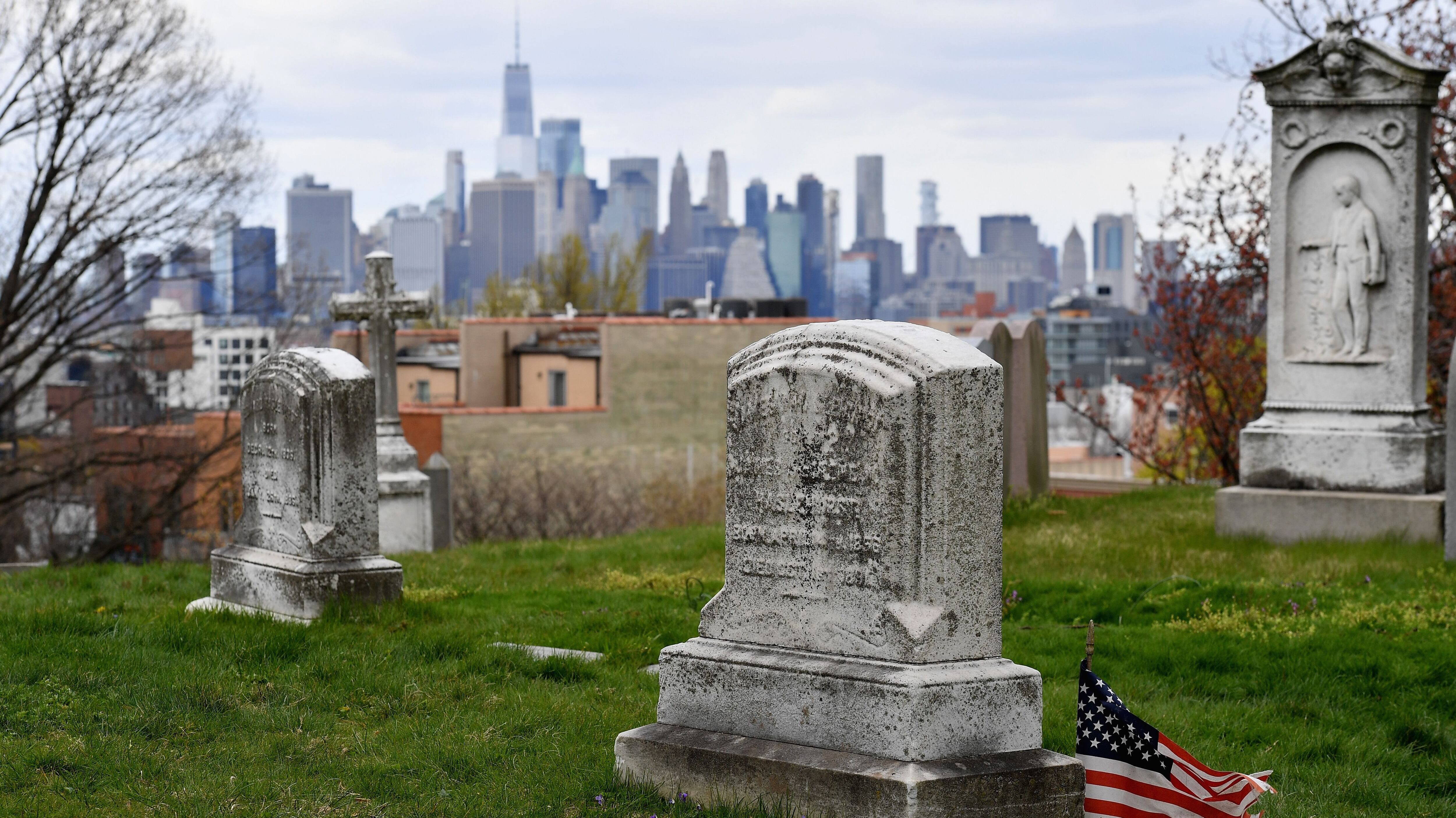 The skyline of lower Manhattan with One World Trade Center is seen from a cemetery on April 10, 2020 in New York City. (Photo by Angela Weiss / AFP) (Photo by ANGELA WEISS/AFP via Getty Images)