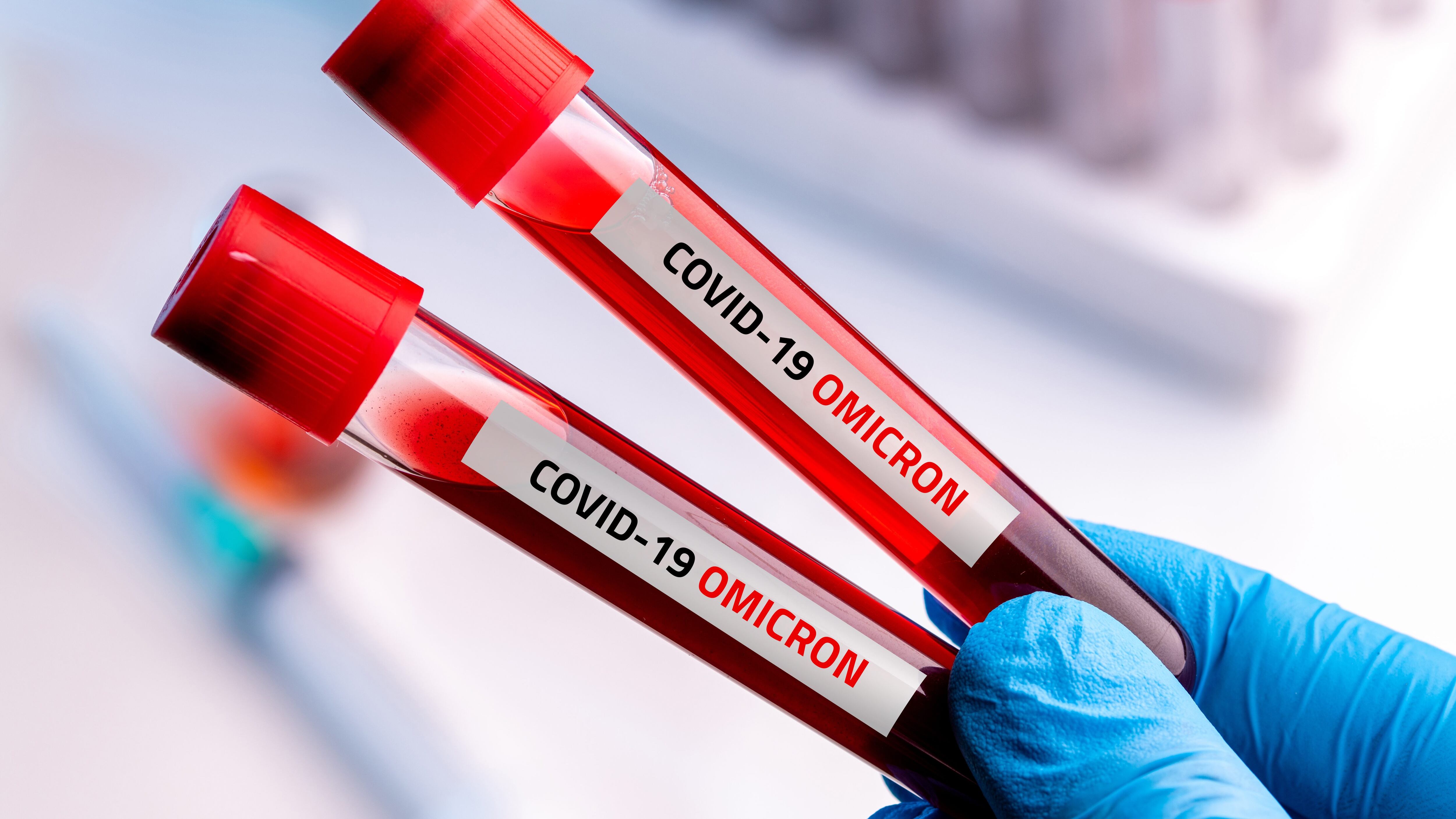 Doctor with blood sample of Covid-19 Omicron B.1.1.529 Variant and general data of covid-19 Coronavirus Mutations.