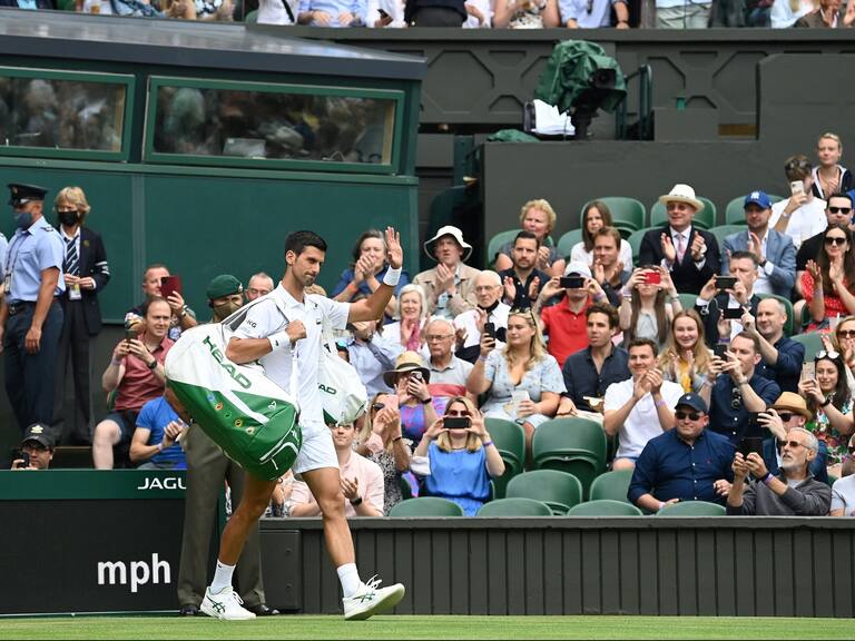 Chile's Cristian Garin (L) and Serbia's Novak Djokovic arrive on court for their men's singles fourth round match on the seventh day of the 2021 Wimbledon Championships at The All England Tennis Club in Wimbledon, southwest London, on July 5, 2021. - RESTRICTED TO EDITORIAL USE (Photo by Glyn KIRK / AFP) / RESTRICTED TO EDITORIAL USE (Photo by GLYN KIRK/AFP via Getty Images)