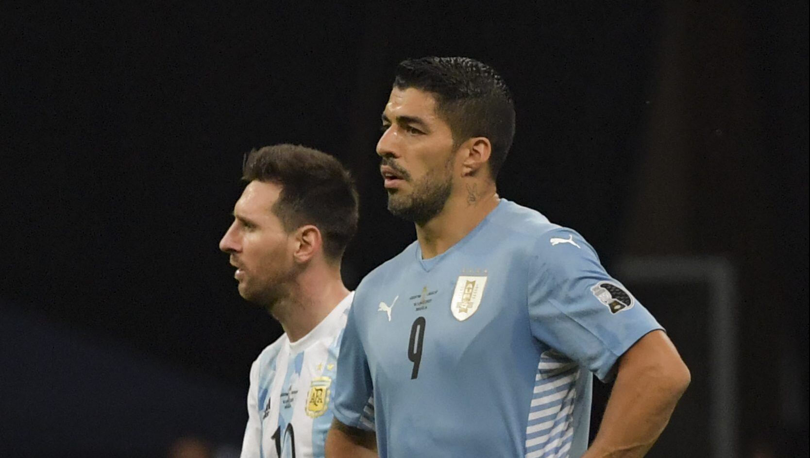 Argentina's Lionel Messi (L) and Uruguay's Luis Suarez are pictured during their Conmebol Copa America 2021 football tournament group phase match at the Mane Garrincha Stadium in Brasilia, on June 18, 2021. (Photo by NELSON ALMEIDA / AFP) (Photo by NELSON ALMEIDA/AFP via Getty Images)