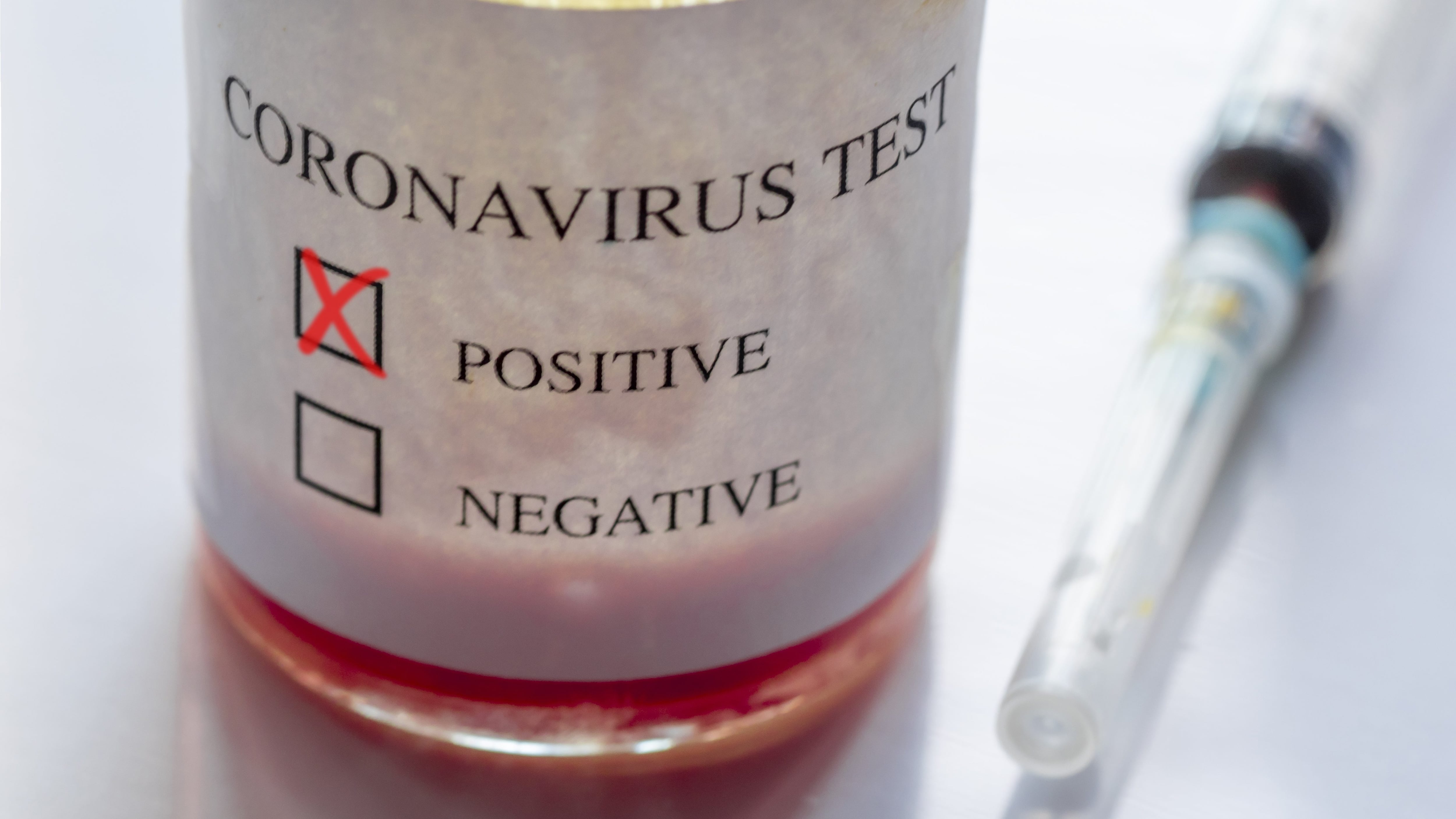 Syringe and ampoule containing coronavirus positive blood test