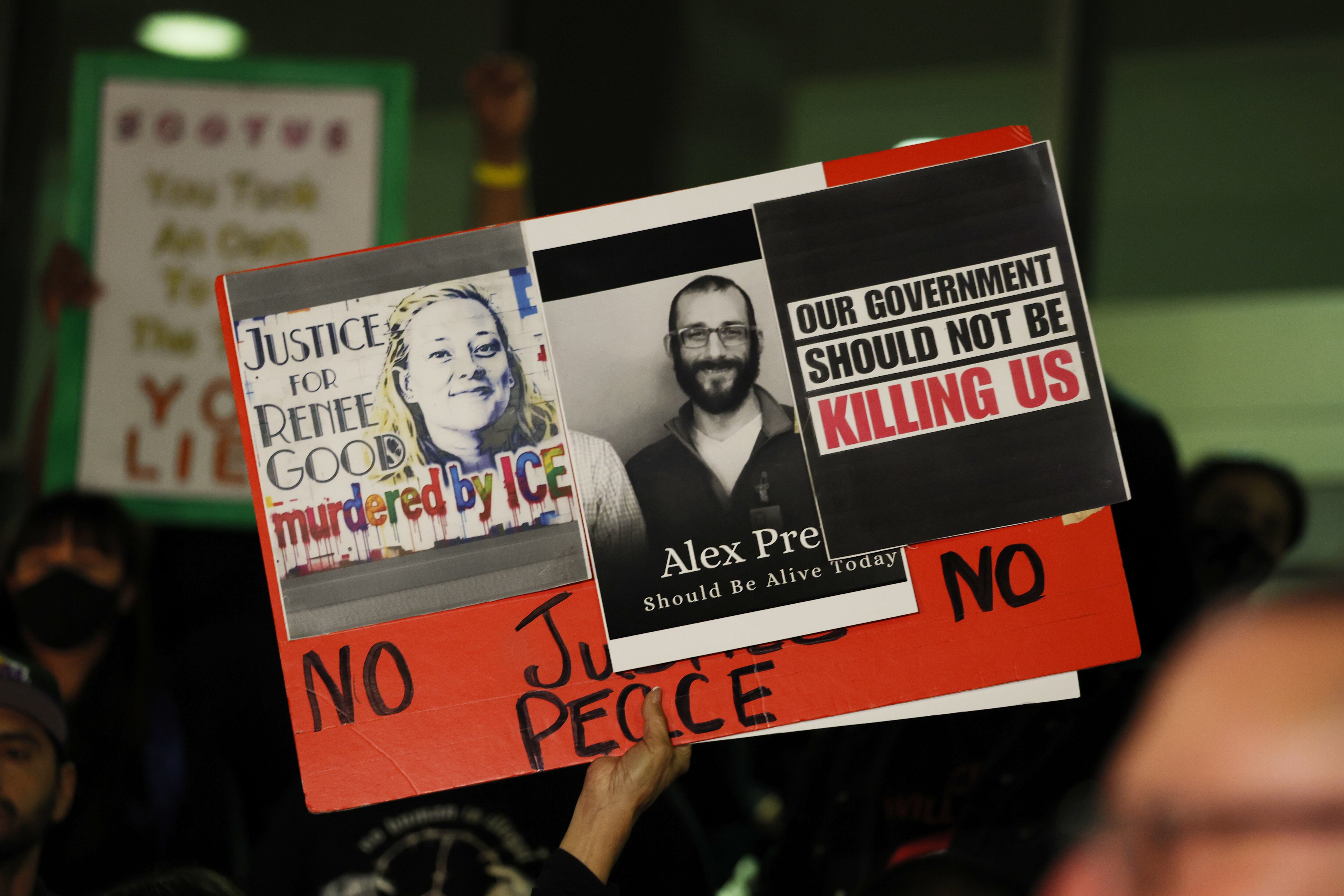 Los Angeles, CA - January 24: A sign is raised in support of Renee Good and Alex Pretti at a candle light vigil during a peaceful protest.  (Gina Ferazzi / Los Angeles Times via Getty Images)