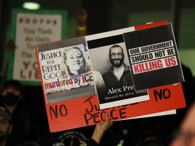 Los Angeles, CA - January 24: A sign is raised in support of Renee Good and Alex Pretti at a candle light vigil during a peaceful protest. (Gina Ferazzi / Los Angeles Times via Getty Images)
