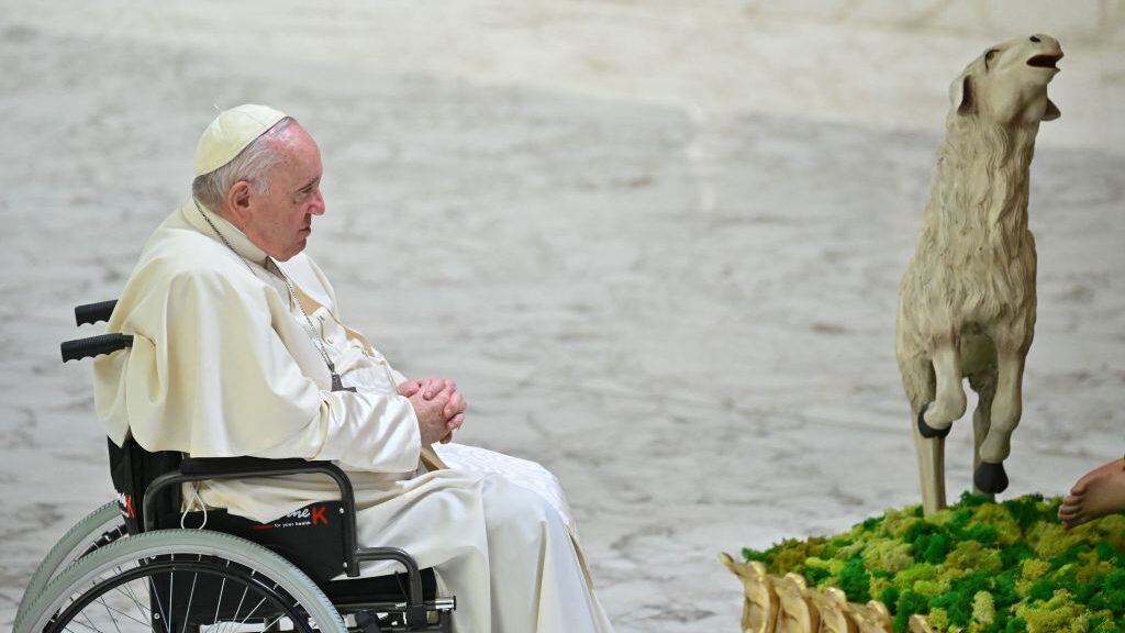 Pope Francis prays by a Nativity Scene during the weekly general audience on December 14, 2022 at Paul-VI hall in The Vatican. (Photo by Filippo MONTEFORTE / AFP) (Photo by FILIPPO MONTEFORTE/AFP via Getty Images)