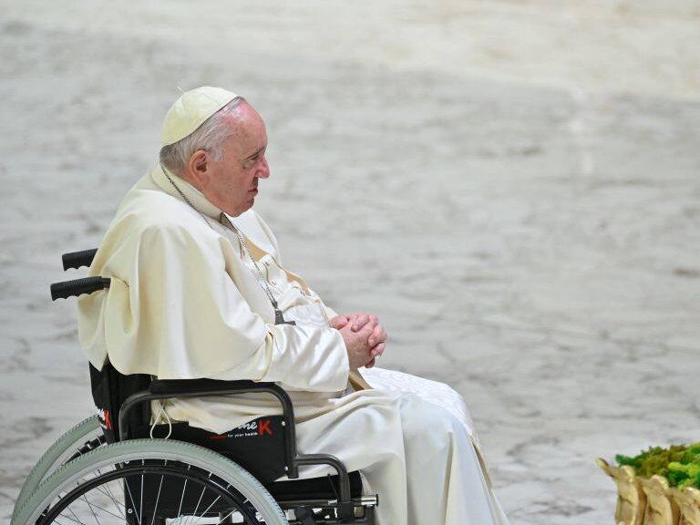 Pope Francis prays by a Nativity Scene during the weekly general audience on December 14, 2022 at Paul-VI hall in The Vatican. (Photo by Filippo MONTEFORTE / AFP) (Photo by FILIPPO MONTEFORTE/AFP via Getty Images)