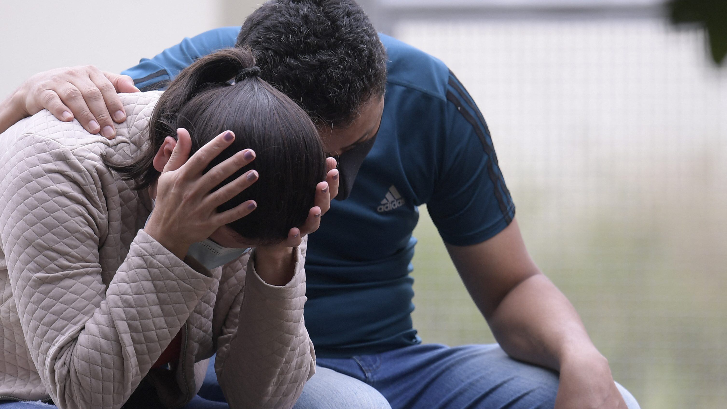 Relatives of a victim wait outside the Legal Medicine Institute of Passos, Minas Gerais State, Brazil, on January 9, 2022, a day after a large rock fragment broke off a ravine and plunged onto several tourist boats leaving ten people dead at the nearby canyons of Furnas Lake. - Ten people died when a cliff collapsed onto tourist boats on a lake in Brazil, officials said Sunday after the bodies of two missing people were found. (Photo by Douglas MAGNO / AFP) (Photo by DOUGLAS MAGNO/AFP via Getty Images)