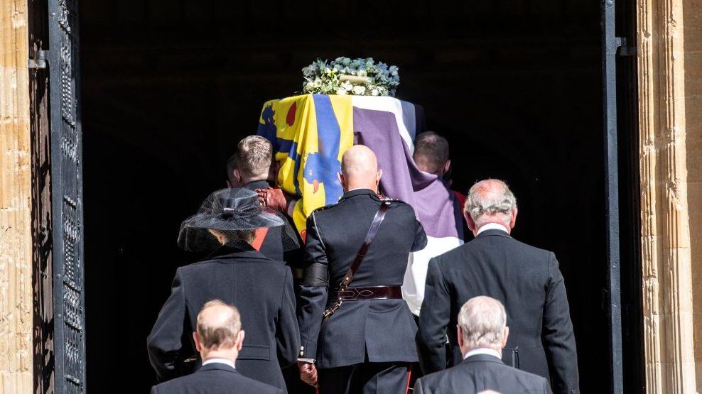 WINDSOR, ENGLAND - APRIL 17: Members of the royal family follow Prince Philip, Duke of Edinburgh’s coffin, covered with His Royal Highness’s Personal Standard as it arrives at St George’s Chapel carried by a bearer party found by the Royal Marines during the funeral of Prince Philip, Duke of Edinburgh at Windsor Castle on April 17, 2021 in Windsor, England. Prince Philip of Greece and Denmark was born 10 June 1921, in Greece. He served in the British Royal Navy and fought in WWII. He married the then Princess Elizabeth on 20 November 1947 and was created Duke of Edinburgh, Earl of Merioneth, and Baron Greenwich by King VI. He served as Prince Consort to Queen Elizabeth II until his death on April 9 2021, months short of his 100th birthday. His funeral takes place today at Windsor Castle with only 30 guests invited due to Coronavirus pandemic restrictions. (Photo by Richard Pohle - WPA Pool/Getty Images)