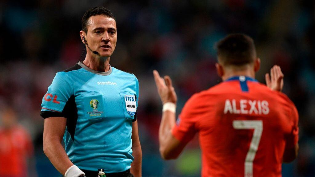 Colombian referee Wilmar Roldan looks at Chile's Alexis Sanchez as he conducts the Copa America football tournament semi-final match between Chile and Peru at the Gremio Arena in Porto Alegre, Brazil, on July 3, 2019. (Photo by Juan MABROMATA / AFP)        (Photo credit should read JUAN MABROMATA/AFP via Getty Images)