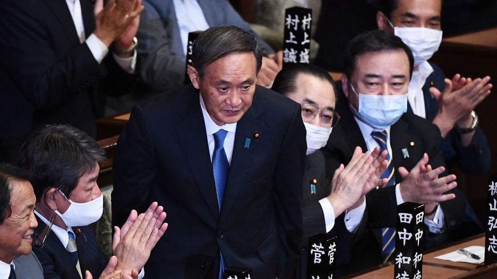 Newly elected leader of Japan's Liberal Democratic Party (LDP) Yoshihide Suga (C) is applauded after he was elected as Japan's prime minister by the Lower House of parliament in Tokyo on September 16, 2020. - Japan's parliament votes on September 16 for the country's next prime minister, with powerful cabinet secretary Yoshihide Suga all but assured the top job, as Shinzo Abe ends his record-breaking tenure. (Photo by CHARLY TRIBALLEAU / AFP) (Photo by CHARLY TRIBALLEAU/AFP via Getty Images)