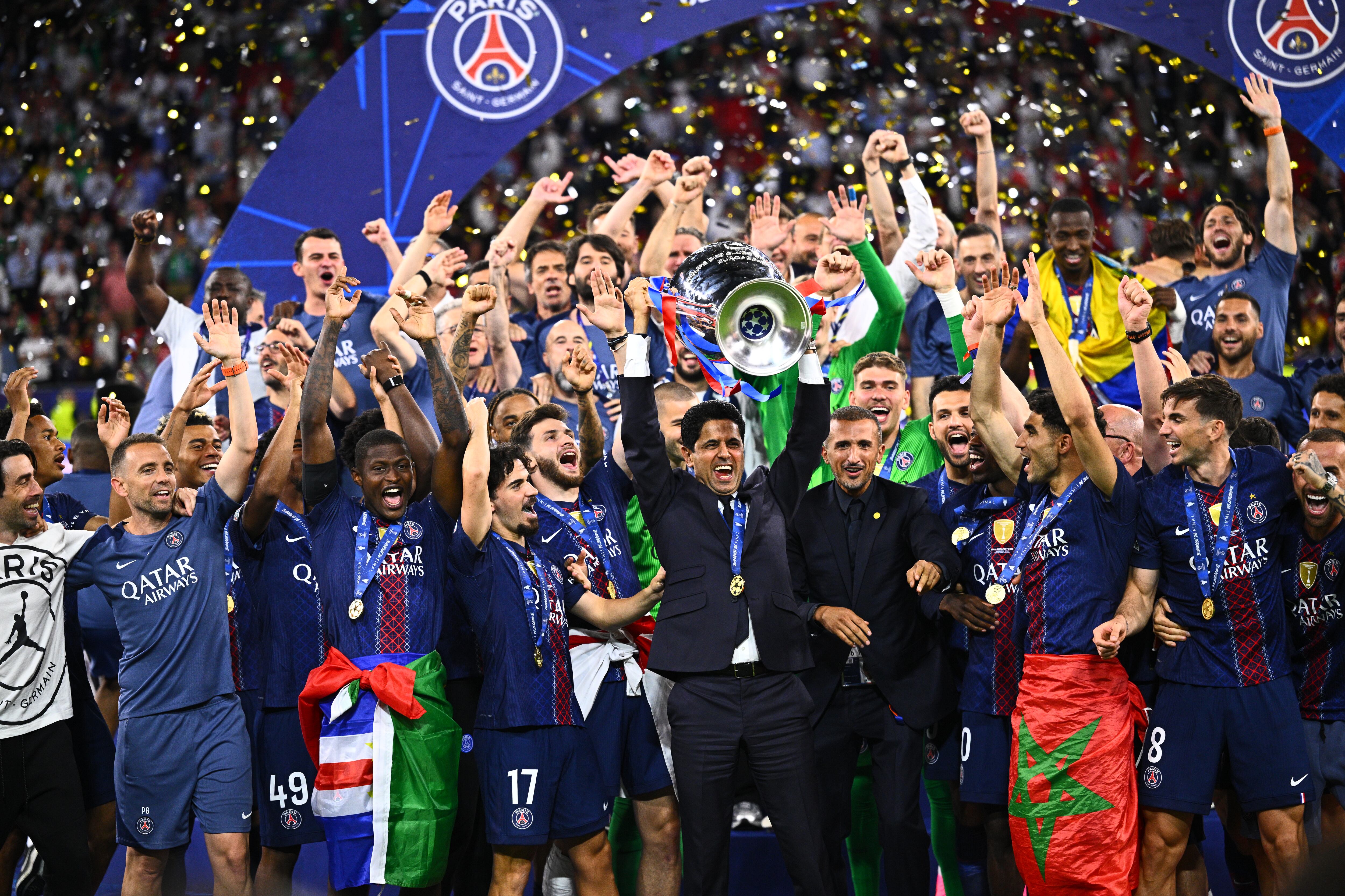 30 May 2026, Hungary, Budapest: Soccer, Men: Champions League, Paris Saint-Germain (PSG) - FC Arsenal, Final, Puskás Aréna, Nasser Ghanim Al-Khelaifi (M), President of Paris Saint-Germain, celebrates with the Champions League trophy after winning the penalty shoot-out, while his players celebrate. Photo: Tom Weller/dpa (Photo by Tom Weller/picture alliance via Getty Images)