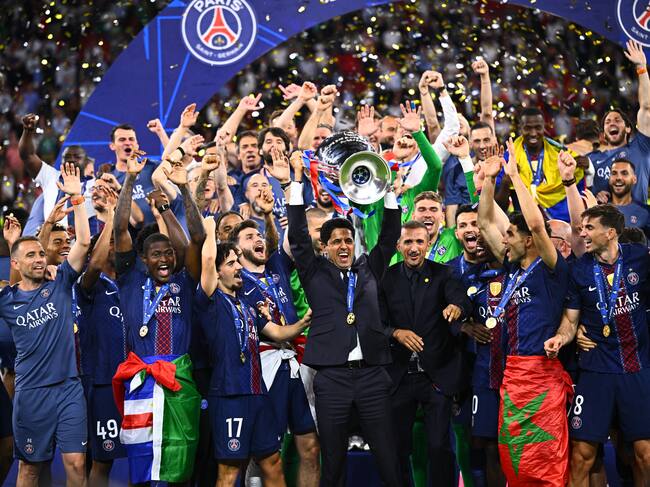 30 May 2026, Hungary, Budapest: Soccer, Men: Champions League, Paris Saint-Germain (PSG) - FC Arsenal, Final, Puskás Aréna, Nasser Ghanim Al-Khelaifi (M), President of Paris Saint-Germain, celebrates with the Champions League trophy after winning the penalty shoot-out, while his players celebrate. Photo: Tom Weller/dpa (Photo by Tom Weller/picture alliance via Getty Images)