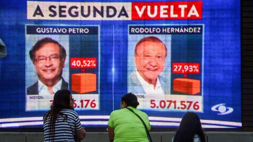 People watch electoral results in a screen during the Colombian presidential election, in Medellin, Colombia, on May 29, 2022. - With more than 97 percent of votes counted, preliminary results showed 62-year-old Gustavo Petro, a former Bogota mayor, leading with 40.3 percent to 28 percent for Rodolfo Hernandez, a 77-year-old populist outsider in surprise second place. (Photo by JOAQUIN SARMIENTO / AFP) (Photo by JOAQUIN SARMIENTO/AFP via Getty Images)
