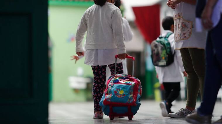 BUENOS AIRES, ARGENTINA - FEBRUARY 17: Schoolchildren enter the Provincia de Cordoba school on February 17, 2021 in Buenos Aires, Argentina. Students of the first years of elementary and secondary school, representing 47% of the total, resume on site lessons after one year of home schooling due to coronavirus pandemic. The rest of the students will return on the following weeks. Government announced strict protocols to prevent spread of the virus. (Photo by Marcos Brindicci/Getty Images)