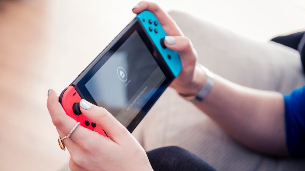Detail of a young woman playing video games on a Nintendo Switch home console, taken on March 7, 2017. (Photo by James Sheppard/Future via Getty Images)