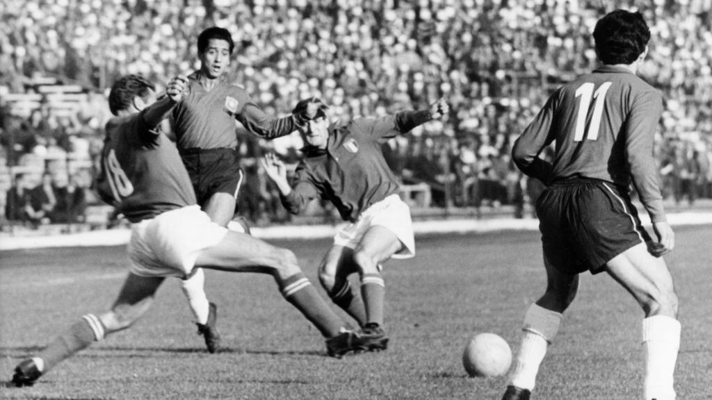Italian defender David (L) tries to reach the ball and lunges forward while Chilean forward Leonel Sanchez (R, no 11) looks on during the 1962 World Cup group game Chile against Italy at the National Stadium in Santiago de Chile, Chile, 2 June 1962. Chile won the game 2-0 in front of 66,000 spectators. The game was considered to be a scandal due to a continues series of fouls and assaults on the pitch which disrupted the game. Davis and Sanchez clashed repeatedly during the game. Two Italian players were sent off whereby one player only left when police officers escorted him off the pitch. (Photo by -/picture alliance via Getty Images)