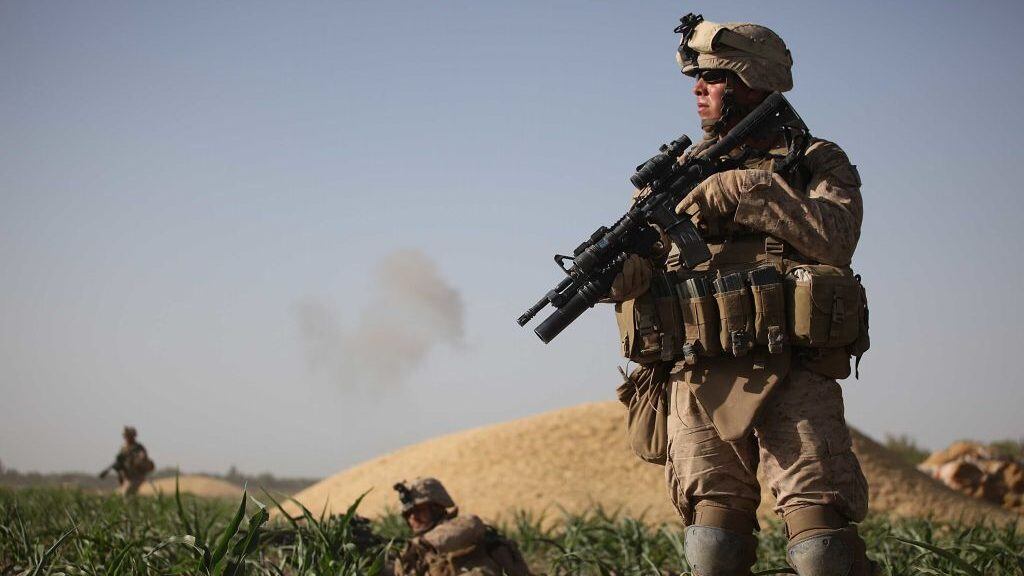 MIAN POSHTEH, AFGHANISTAN- JULY 17:  U.S. Marines with the 2nd Marine Expeditionary Brigade, RCT 2nd Battalion 8th Marines Echo Co. look for targets after taking enemy fire on July 17, 2009 in Mian Poshteh, Afghanistan. The Marines are part of Operation Khanjari which was launched to take areas in the Southern Helmand Province that Taliban fighters are using as a resupply route and to help the local Afghan population prepare for the upcoming presidential elections.  (Photo by Joe Raedle/Getty Images)