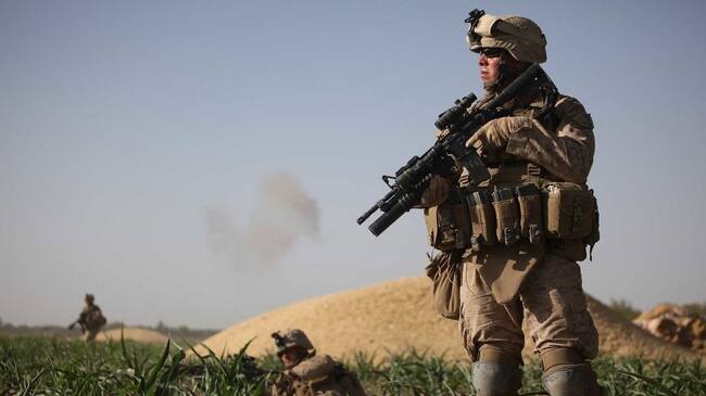 MIAN POSHTEH, AFGHANISTAN- JULY 17: U.S. Marines with the 2nd Marine Expeditionary Brigade, RCT 2nd Battalion 8th Marines Echo Co. look for targets after taking enemy fire on July 17, 2009 in Mian Poshteh, Afghanistan. The Marines are part of Operation Khanjari which was launched to take areas in the Southern Helmand Province that Taliban fighters are using as a resupply route and to help the local Afghan population prepare for the upcoming presidential elections. (Photo by Joe Raedle/Getty Images)