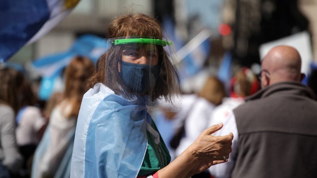 Woman with chinstrap protests against the transfer of judges in front of the Courts in Buenos Aires, Argentina on October 1, 2020. (Photo by Carol Smiljan/NurPhoto via Getty Images)