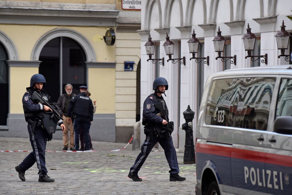 VIENNA, AUSTRIA - NOVEMBER 03: Policemen walk past markings on the ground showing one of the crime scenes in the city center the day after a deadly shooting spree on November 03, 2020 in Vienna, Germany. One gunman, identified as a Chechen man who had sworn alliance to the Islamic State (IS), was shot and killed by police after he ran shooting with a long gun through an area with restaurants and cafes. So far four people are confirmed dead and 17 wounded. Police are searching for a second possible suspect. (Photo by Thomas Kronsteiner/Getty Images)