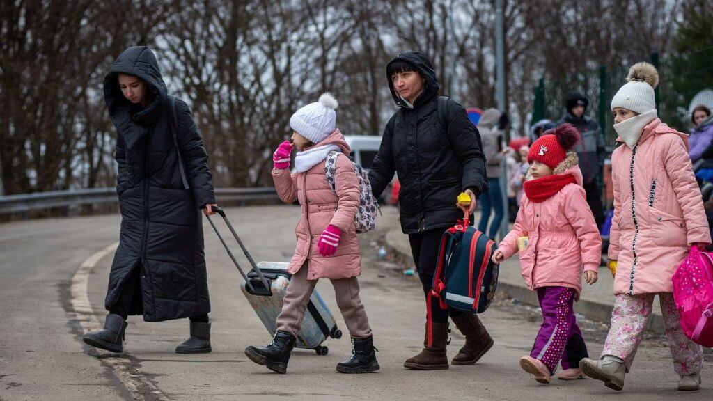 Ukrainian women and children leave Ukraine after crossing the Slovak-Ukrainian border in Ubla, eastern Slovakia, close to the Ukrainian city of Welykyj Beresnyj, on February 25, 2022, following Russia's invasion of the Ukraine. - Ukrainian citizens have started to flee the conflict in their country one day after Russia launched a military attack on neighbouring Ukraine. (Photo by PETER LAZAR / AFP) / The erroneous mention[s] appearing in the metadata of this photo by PETER LAZAR has been modified in AFP systems in the following manner: [in Ubla, eastern Slovakia, close to the Ukrainian city of Welykyj Beresnyj] instead of [in Vysne Nemecke, eastern Slovakia, close to the Ukrainian city of Uzhorod]. Please immediately remove the erroneous mention[s] from all your online services and delete it (them) from your servers. If you have been authorized by AFP to distribute it (them) to third parties, please ensure that the same actions are carried out by them. Failure to promptly comply with these instructions will entail liability on your part for any continued or post notification usage. Therefore we thank you very much for all your attention and prompt action. We are sorry for the inconvenience this notification may cause and remain at your disposal for any further information you may require. (Photo by PETER LAZAR/AFP via Getty Images)