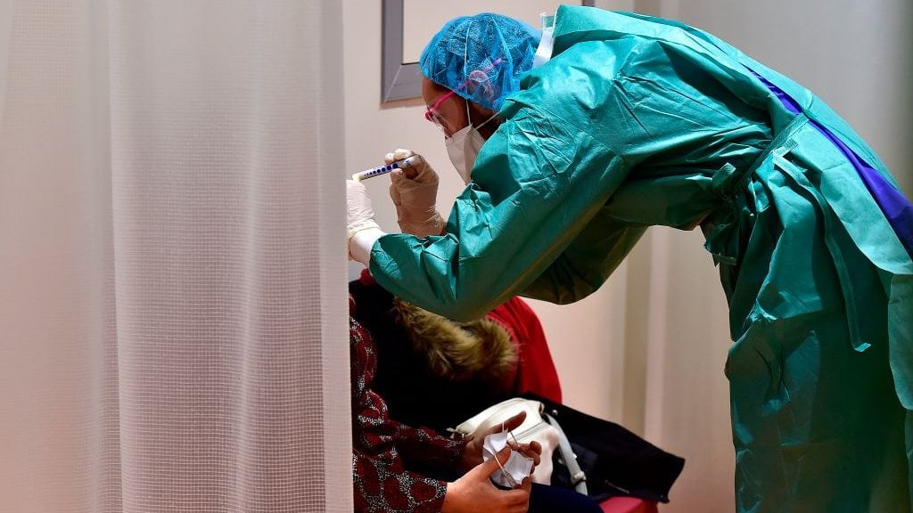 A doctor examines a patient at the hospital screening unit of the CHU Pellegrin in Bordeaux, southwestern France on March 9, 2020. - The CHU Pellegrin in Bordeaux has opened a screening unit for the novel coronavirus where patients are examined in a box by a team made up of doctors and nurses who take samples, before senidng them the virology laboratory to confirm or not the infection by the novel coronavirus.With 1,191 recorded cases and 21 deaths, France is the second-worst affected European country after neighbour Italy, which has imposed a sweeping lockdown on the most hard-hit northern regions. (Photo by GEORGES GOBET / AFP) (Photo by GEORGES GOBET/AFP via Getty Images)