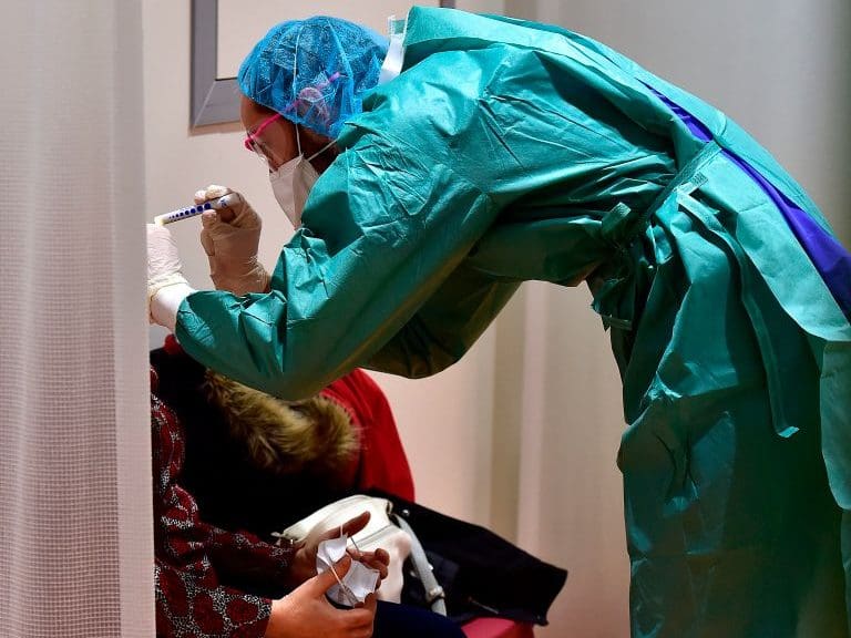 A doctor examines a patient at the hospital screening unit of the CHU Pellegrin in Bordeaux, southwestern France on March 9, 2020. - The CHU Pellegrin in Bordeaux has opened a screening unit for the novel coronavirus where patients are examined in a box by a team made up of doctors and nurses who take samples, before senidng them the virology laboratory to confirm or not the infection by the novel coronavirus.With 1,191 recorded cases and 21 deaths, France is the second-worst affected European country after neighbour Italy, which has imposed a sweeping lockdown on the most hard-hit northern regions. (Photo by GEORGES GOBET / AFP) (Photo by GEORGES GOBET/AFP via Getty Images)