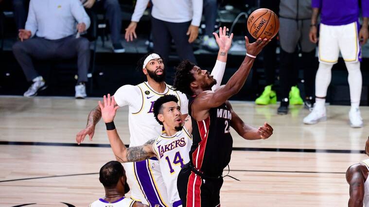 LAKE BUENA VISTA, FLORIDA - OCTOBER 04: Jimmy Butler #22 of the Miami Heat drives to the basket against Danny Green #14 of the Los Angeles Lakers during the second half in Game Three of the 2020 NBA Finals at AdventHealth Arena at ESPN Wide World Of Sports Complex on October 04, 2020 in Lake Buena Vista, Florida. NOTE TO USER: User expressly acknowledges and agrees that, by downloading and or using this photograph, User is consenting to the terms and conditions of the Getty Images License Agreement. (Photo by Douglas P. DeFelice/Getty Images)