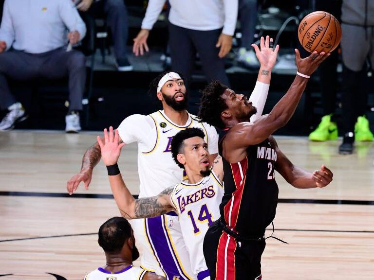 LAKE BUENA VISTA, FLORIDA - OCTOBER 04: Jimmy Butler #22 of the Miami Heat drives to the basket against Danny Green #14 of the Los Angeles Lakers during the second half in Game Three of the 2020 NBA Finals at AdventHealth Arena at ESPN Wide World Of Sports Complex on October 04, 2020 in Lake Buena Vista, Florida. NOTE TO USER: User expressly acknowledges and agrees that, by downloading and or using this photograph, User is consenting to the terms and conditions of the Getty Images License Agreement. (Photo by Douglas P. DeFelice/Getty Images)