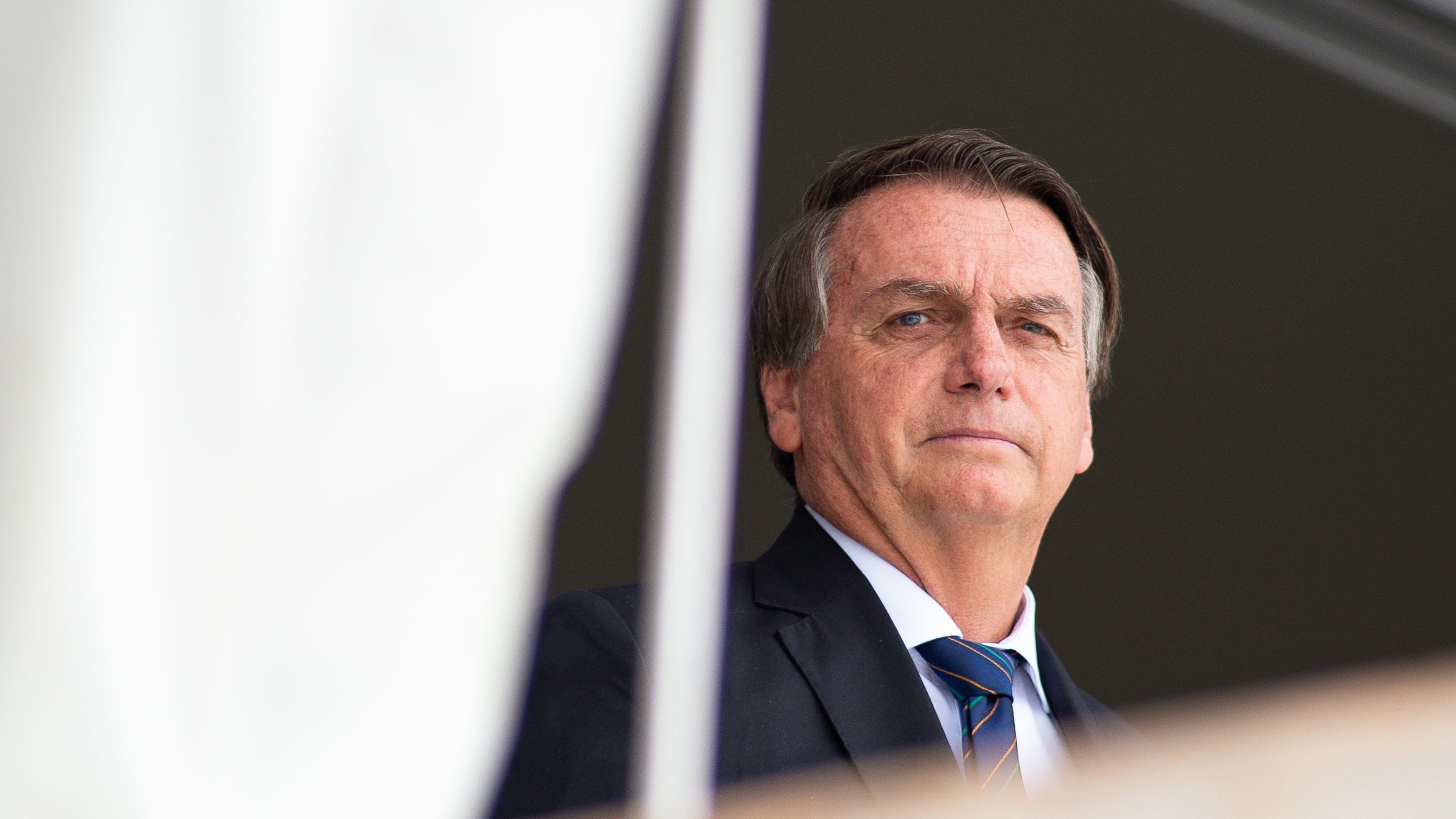 BRASILIA, BRAZIL - DECEMBER 16: President of Brazil Jair Bolsonaro reacts during the exchange of the presidential guard at Planalto Palace on December 16, 2021 in Brasilia, Brazil. (Photo by Andressa Anholete/Getty Images)