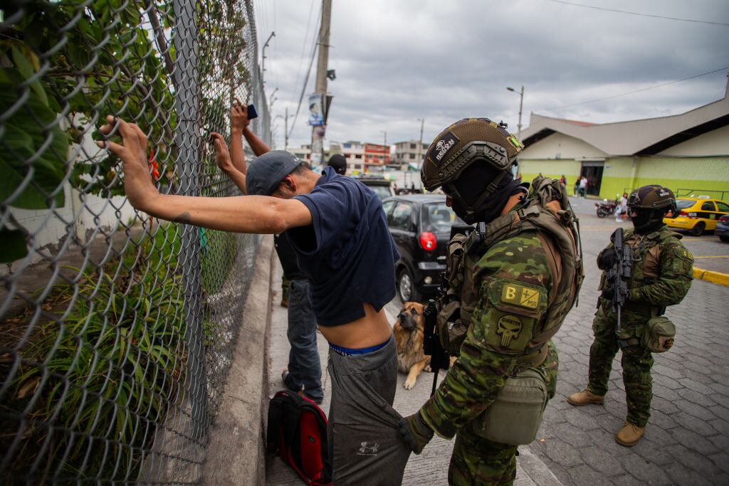 Un grupo de soldados de Ecuador revisa a un civil en un barrio de la ciudad de Quito, en medio de la ola de violencia que lanzaron las bandas criminales.