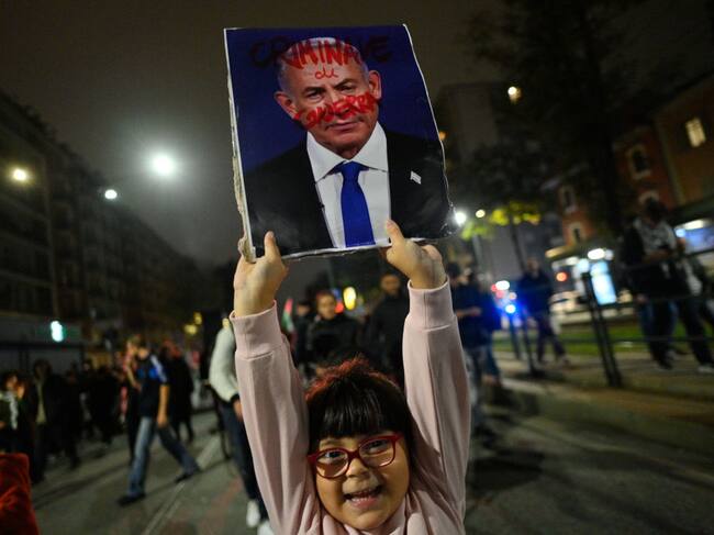 Una niña en Italia porta un cartel que muestra ensangrentado al primer ministro de Israel, Benjamin Netanyahu, por los ataques contra la Franja de Gaza