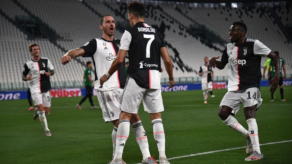 Juventus' Portuguese forward Cristiano Ronaldo (C) celebrates with Juventus' Italian defender Leonardo Bonucci (L) and Juventus' French midfielder Blaise Matuidi (R) after scoring a penalty during the Italian Serie A football match Juventus Turin vs Atalanta Bergamo played behind closed doors on July 11, 2020 at the Juventus stadium in Turin, as the country eases its lockdown aimed at curbing the spread of the COVID-19 infection, caused by the novel coronavirus. (Photo by Marco Bertorello / AFP) (Photo by MARCO BERTORELLO/AFP via Getty Images)