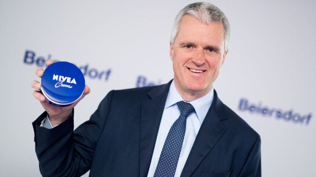 CEO of Beiersdorf Stefan Heidenreich holds up a tube of Nivea cream during the company's financial statement press conference, in Hamburg, Germany, 01 March 2018. Photo: Daniel Reinhardt/dpa (Photo by Daniel Reinhardt/picture alliance via Getty Images)